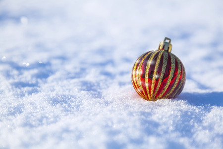 bright christmas decoration lying on snow backgroundの写真素材