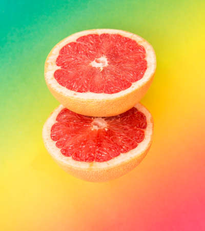two parts of grapefruit on a colored backgroundの写真素材