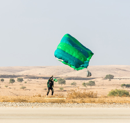 athlete landed safely by parachute on the background of the desert