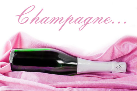 closed bottle of champagne wrapped in pink tissueの写真素材