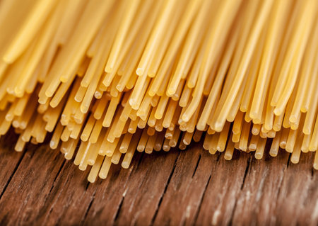 spaghetti posted on the a row on a wooden background