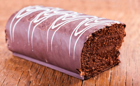 sweet roll with chocolate on a wooden backgroundの写真素材