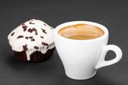cupcake and cup of coffee on a dark backgroundの写真素材