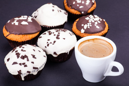 cup of coffee and muffins on a dark backgroundの写真素材