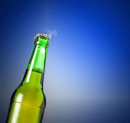 lager beer in bottle on a blue backgroundの写真素材