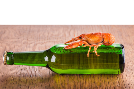 glass bottle of beer and crayfish on a white backgroundの写真素材