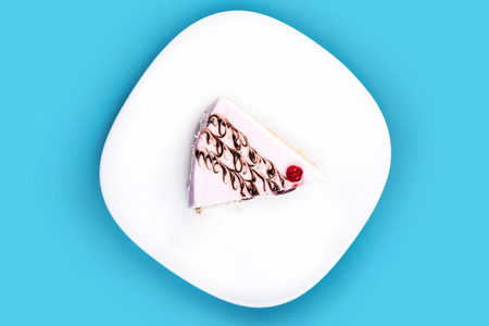 vanilla piece of cake on a blue backgroundの写真素材