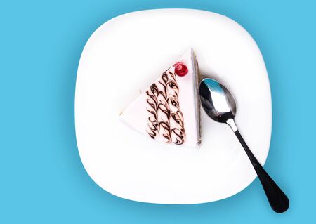 vanilla slice of cake on a blue backgroundの写真素材