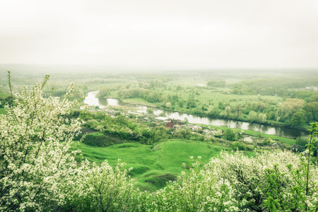 village and river landscape view from hill in spring