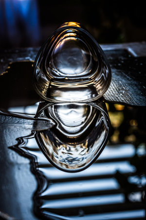 spilled glass of whiskey on the table on a dark background