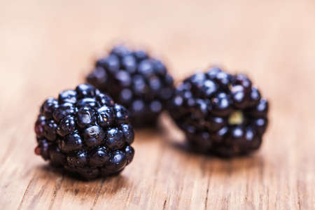 natural fresh blackberrys closeup on wooden backgroundの写真素材