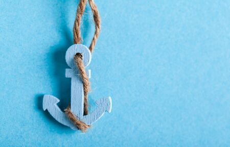 the small anchor close-up on a blue backgroundの写真素材
