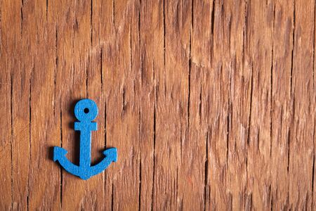 small anchor close-up on a wooden vintage backgroundの写真素材