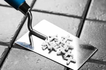 the trowel closeup on a background of ceramic tileの写真素材