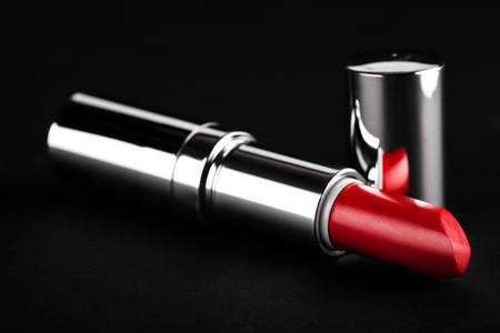 open red lipstick closeup on a black backgroundの写真素材