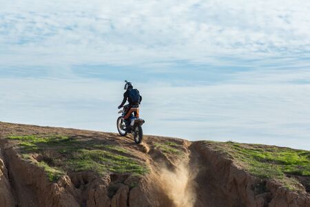 racer on a motorcycle in the desert summer dayの写真素材