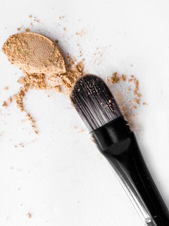 scattered beige eye shadow on a white backgroundの写真素材