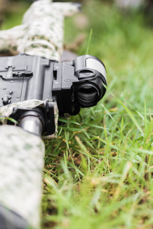 military weapon rifle close-up on green grass