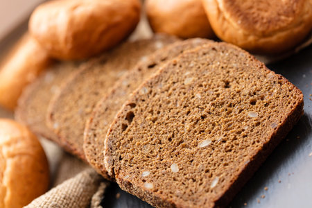 fresh sliced rye bread on a dark background