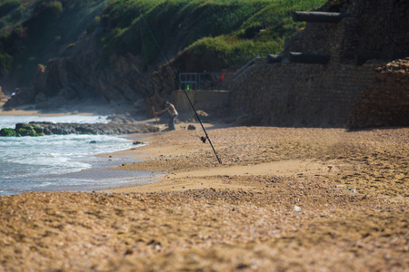 blue sea landscape with a fishing rod on the shoreの写真素材