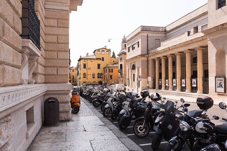 scooters parked on the street in a rowのeditorial素材