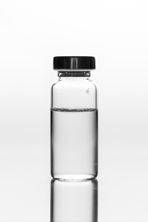 medicament in a glass vial on white backgroundの写真素材