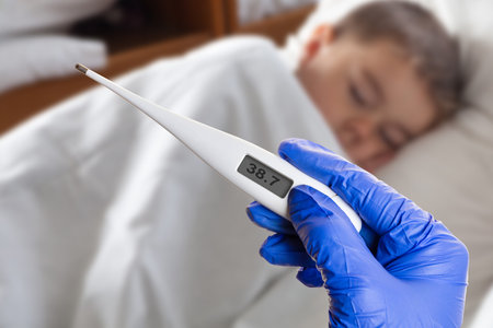 thermometer in hand on a background sick child