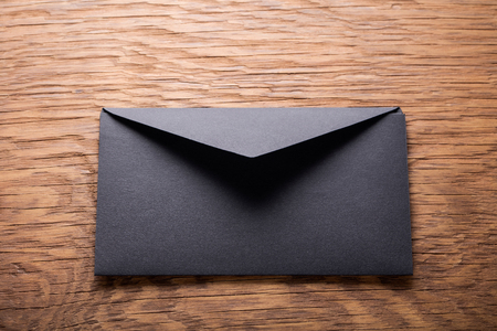 black envelope on  wooden tableの写真素材