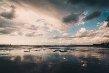 Sea waves with a reflection on the shoreの写真素材