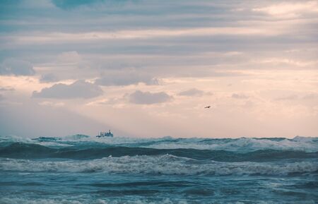 the landscape sea waves on sunset backgroundの写真素材