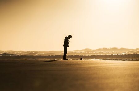 silhouette of a child on the sea shoreの写真素材