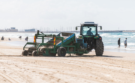 ASHDOD, ISRAEL - January 13, 2017: tractor cleans the sand on the beachのeditorial素材