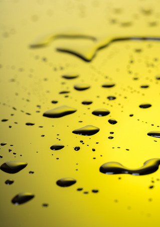 Abstract background, water droplets on black-and-yellow plasticの写真素材