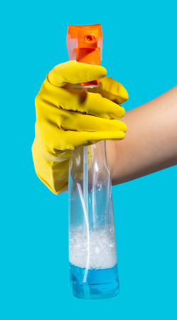 Detergent for cleaning in a female hand on blue backgroundの写真素材