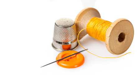spool of thread and buttons on white isolated backgroundの写真素材