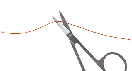 scissors cut the thread on a white isolated background