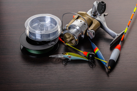 Coil and floats for a fishing rod on a wooden backgroundの写真素材