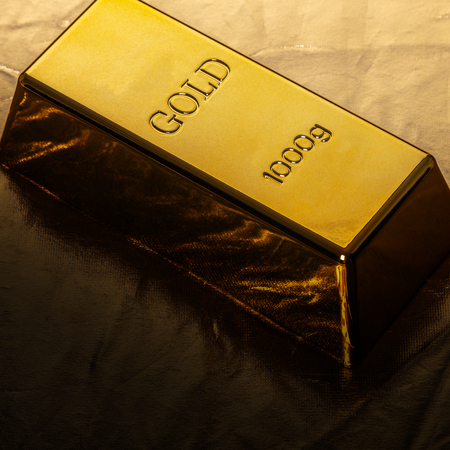 bar of gold close-up on golden backgroundの写真素材