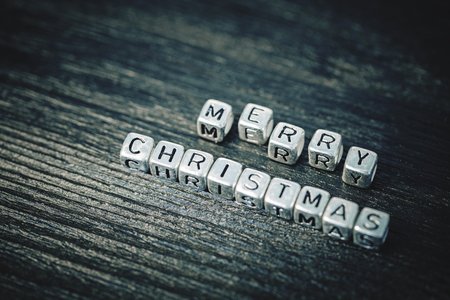 inscription Merry Christmas on black wooden backgroundの写真素材