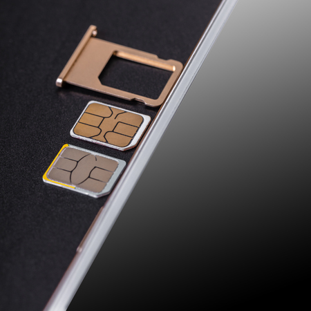 mobile phone and sim card on a black background