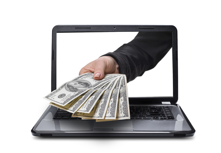 hand with money coming out of laptop, isolated white backgroundの写真素材