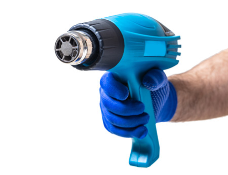 construction tool, hairdryer in male hand on white isolated backgroundの写真素材