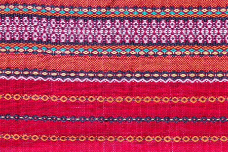 abstract background of red fabric texture with ukrainian ornamentの写真素材