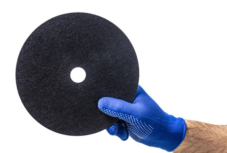 Circles for electric saw in male hand on white isolated backgroundの写真素材