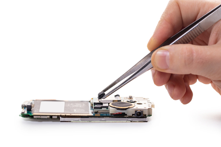 mobile phone repair, hands closeup on a white isolated backgroundの写真素材