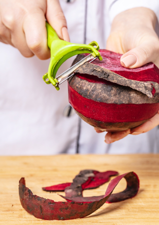 cook cleans beet, preparing vegetables for cookingの写真素材