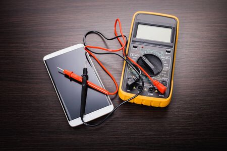 mobile phone and tool on wooden backgroundの写真素材