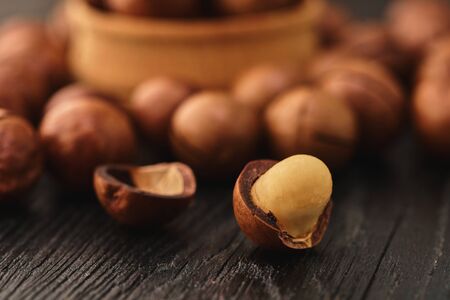 Macadam nut close-up on a black wooden backgroundの写真素材