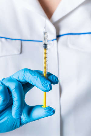 liquid drug or vaccine for treatment, flu in the hand of the doctor close-upの写真素材