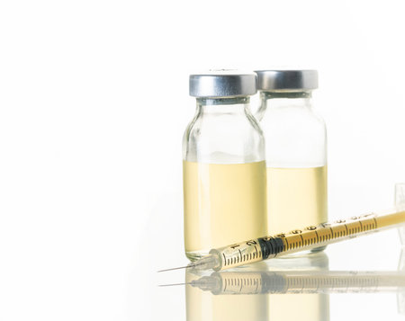 syringe and medicine bottle on white background